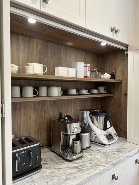 Custom designed polyurethane appliance cabinet, constructed in a timber grain Lamiwood with round LED lighting. Fitted with bi-fold opening doors and a 40mm natural stone benchtop. #kitchensbyemanuel #customjoinery #appliancecabinet #storagegoals #appliancecabinet Types Of Kitchen Cabinets, Stone Benchtop, Appliance Cabinet, Coffee Bar Home, Opening Doors, Coffee Station, Home Reno, Led Lighting, Joinery