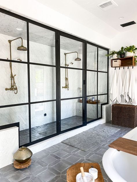 A Los Angeles home filled with eclectic elements. This bathroom features a Schumacher Iksel wall mural of an Indian bathing scene. Flowing curtains and bohemian wood details add the perfect touch to this bathroom. Vintage brass fixtures throughout, such as these double shower heads in the walk-in shower. Open Concept Bathroom, Double Shower Heads, Big Shower, Casa Hobbit, Latest Bathroom, Double Shower, Master Shower, Master Bath Remodel, Kitchen And Bath Design