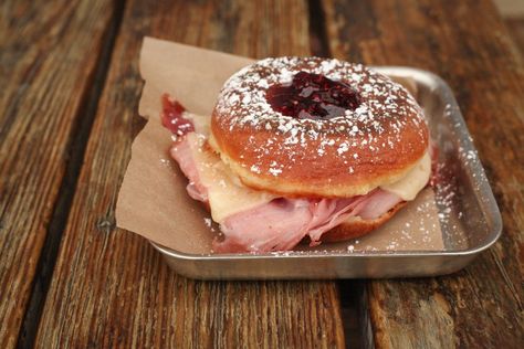 Bakery: Donuts and Sliders Location: New Orleans, Louisiana This grilled donut sandwich is filled with smoked ham, Havarti, and Dijon, and topped with preserves and powdered sugar for a doughy blend of salty and sweet. For more information, visit donutsandsliders.com.   - Delish.com Doughnut Sandwich, Donut Brunch, Donut Sandwich, French Donuts, Savory Donuts, Nola Trip, Fair Foods, Donut Flavors, Doughnut Shop