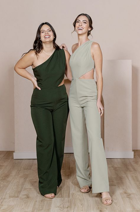 Our Lennon Jumpsuit is now available in all our crepe colors, making it the perfect option for the bridesmaid who desires a unique and edgy alternative to a dress! Lennon is modern and elevated in its design, featuring a one-shoulder draped bodice and a mid-size side cut-out that hits near the waist on the left side wi Sage Jumpsuit Wedding, Wedding Guest Outfit Gender Neutral, Bridesmaid Pantsuit Wedding, Bridesmaid Jumper, Fancy Jumpsuit Wedding, Officiant Outfit Female, Wedding Jumpsuit Guest, Tomboy Wedding Outfit Guest, Bridesmaid Suits For Women