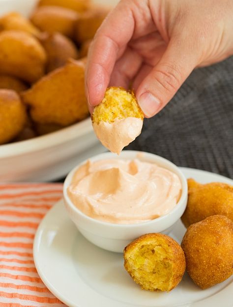 Hushpuppies #Recipe | browneyedbaker.com Seafood Menu Ideas, Hushpuppies Recipe, Seafood Broil, Hush Puppies Recipe, Brown Eyed Baker, Spicy Dipping Sauce, Seafood Menu, Dipping Sauces, Starters Recipes