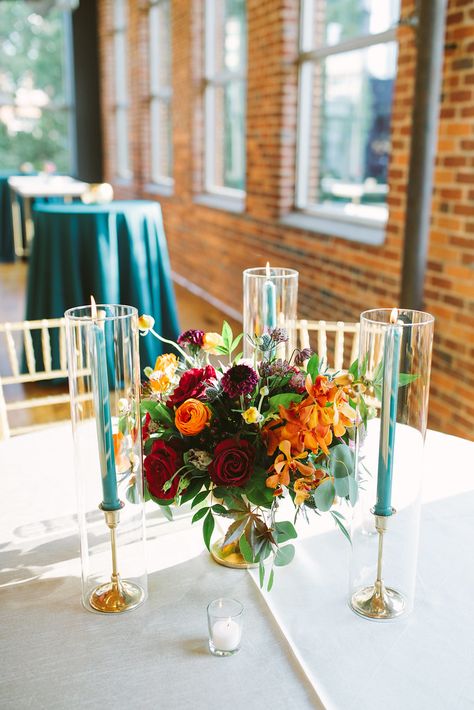 Teal Candles Wedding, Teal Burgundy Orange Wedding, Simple Jewel Tone Wedding Centerpieces, Emerald Green And Burnt Orange Wedding Centerpieces, Jewel Tone Ceremony, Jewel Tone Wedding Table, Teal Blue Bridesmaid Dresses, Burgundy And Orange Wedding, Teal Wedding Centerpieces