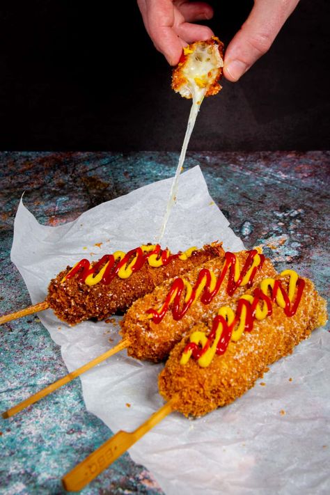 The Korean Corn Dog is like an American corn dog on steroids. The ultra crispy, sugary panko coating and melty mozzarella cheese will surely put a smile on your face. #korean #koreancorndog #deepfried #snacks #superbowlsnacks Corn Dog Recipe, Korean Corn Dog, American Corn, Korean Corn, Corndog Recipe, Spicy Corn, Korean Street Food Recipes, Carnival Food, Cheese Dog