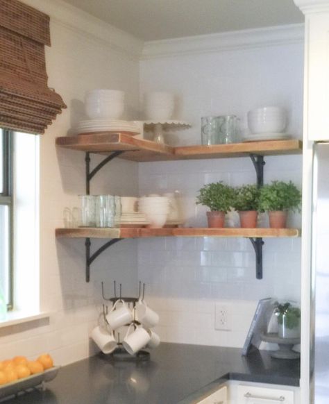 Shanty Sisters on Instagram: “Simple corner shelves! We bought 4 inexpensive metal brackets and one 2x12 board from Home Depot. Each "L" is created by joining a 24" board and a 35" board using pocket hole screws. To hold the wood in place you just attach 1" screws through the brackets and into the wood. We stained the wood with Varathane stain in Early American and distressed it a bit with a sander! LOVE how much it added to this kitchen for under $50! Corner Shelves Kitchen, Diy Corner Shelves, Kitchen Corner Shelves, Corner Shelf Ideas, Kitchen Shelf Decor, Kabinet Dapur, Regal Design, Kitchen Corner, Room Shelves