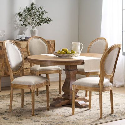 Furnish your dining area in modern farmhouse style with this 5-piece set that includes an oval extendable table and four chairs. All pieces are made from solid and engineered wood and finished in a purposefully distressed hue that highlights the grain variation while also lending a vintage look. The table has a pedestal base and the included leaf extends the width from 40” to more than 57” - so it easily accommodates a small group or a large crowd. The King Louis-style chairs show off graceful t Farmhouse Table Base, Oval Dining Room Table, French Country Fabric, Country Fabric, Round Dining Room Sets, Dining Room French, Nook Table, Modern Farmhouse Table, Round Kitchen Table