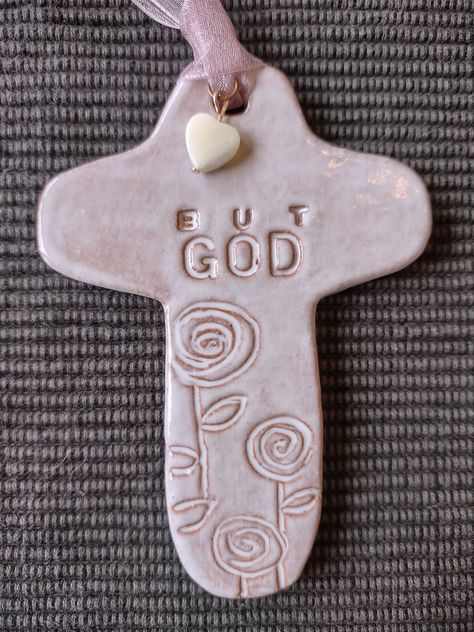 Beautiful "But God "Cross, Psalm 73:26 Ornament.  It is glazed with a white opalescent glaze which adds character to the cross. The hanger is a pinkish colored  ribbon with a white pearl colored heart attached. This ornament is not perfect and flawless rather they show the beauty of being handmade.  Each ornament is handmade with terra cotta pottery clay, bisque fired in a kiln, glazed, fired again. It measures 4 1/4" x 3". Thank you for coming to Charlotte's Room and Norah's Nook where we have fun stuff for everyone! Cross Room Decor, Christian Pottery, Mini Microwave, Psalm 73, God Cross, Microwave Kiln, Terra Cotta Pottery, Clay Cross, Ornament Party