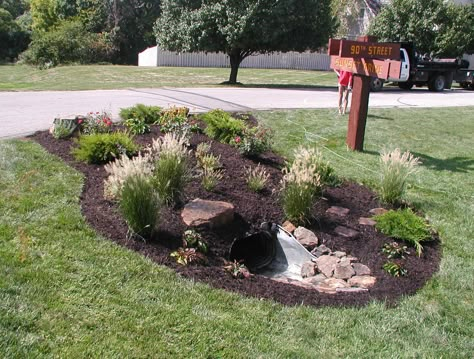 Add a garden area with water loving plants to hide an unattractive area of your yard. This garden hides a culvert located on the corner of the property. Culverts Ideas, Driveway Culvert, Driveway Entrance Landscaping, Mailbox Landscaping, Drainage Ditch, Mulch Landscaping, Driveway Entrance, Driveway Landscaping, Hillside Landscaping