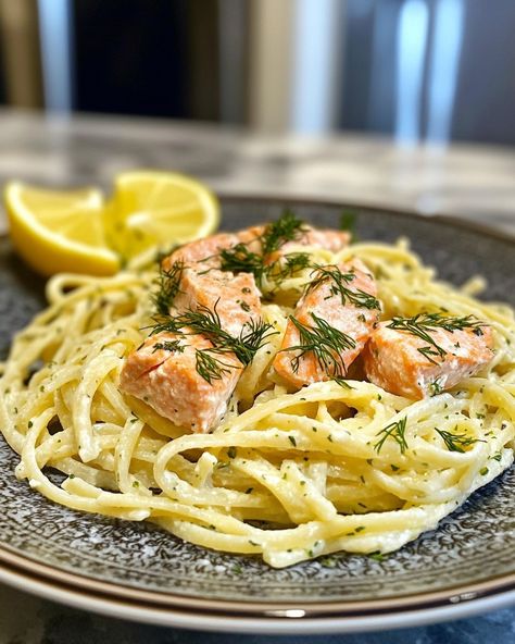 Lemon Dill Salmon Pasta Zesty Lemon Dill Salmon Fettuccine Ingredients: 8 oz fettuccine pasta 2 salmon fillets (6 oz each) 2 tablespoons olive oil 1 tablespoon butter 2 cloves garlic, minced 1/2 cup heavy cream 1/4 cup freshly squeezed lemon juice 1 tablespoon lemon zest 1 tablespoon fresh dill, chopped Salt and pepper to taste 1/4 teaspoon crushed red pepper flakes (optional) Fresh parsley, chopped (for garnish) Directions: Cook the fettuccine according to package instructions until al den... Salmon Fettuccine, Lemon Dill Salmon, Dill Salmon, Fettuccine Pasta, Squeezed Lemon, Lemon Dill, Salmon Pasta, Crushed Red Pepper, Crushed Red Pepper Flakes