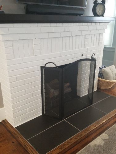 Black tile hearth. White fireplace ideas. Black Tile Hearth, Fireplace Ideas Black, White Fireplace Ideas, Tile Hearth, Cozy Romance, Fireplace Hearth Tiles, Hearth Tiles, White Brick Fireplace, Tall Fireplace