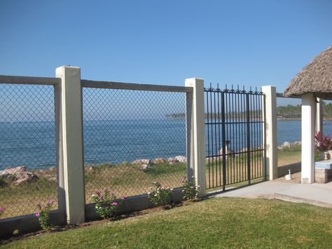 This is my new cyclone fencing, you can still see the old wrought iron gate that was also changed later.  The view of the beach. Beach Front Fence Ideas, Cyclone Fence Ideas, Wall Boundary Design, Boundary Wall Design Modern, Modern Boundary Wall Design, Front Boundary Wall Design, Modern Boundary Wall, Boundary Design, Cyclone Fence