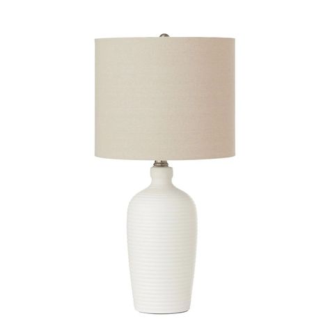 Bring a chic lighting solution to your home with this Hampton Bay Ceramic Table Lamp. Symmetric ribbed design accents the off-white matte ceramic base for an artistic touch. Topped with a clean white drum shade, this lamp will provide amble light to any room. Clear Glass Table Lamp, Table Lamps For Living Room, Table Lamps Modern, Copper Table Lamp, Traditional Table Lamps, Chic Lighting, Bronze Table Lamp, Lamps For Living Room, Tripod Table Lamp