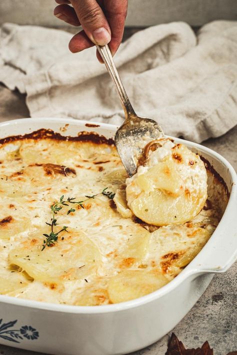 Serving fork scooping out scalloped potatoes from baking dish. Scalloped Potatoes With Caramelized Onions And Gruyere, Gruyere Scalloped Potatoes, Scalloped Potatoes Easy, Carmelized Onions, Vegetarian Main Dishes, Caramelized Onion, Gruyere Cheese, Gobble Gobble, Scalloped Potatoes