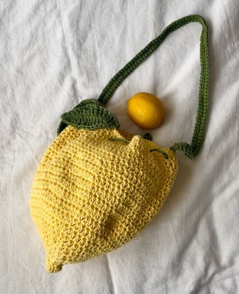 🍋HANDMADE LEMON CROCHET BAG 🍋 Part of the fruit salad collection 🍋100% cotton yarn  🍋37-inch strap 🍋10-inch bag 🍋Realistic lemon shape and leaf *Because all yarn dye is not equal, the bag may vary in color, it'll always be yellow but it ranges in vibrancy. Either way, it's cute AF ;) Lemon Crochet Top, Yellow Yarn Crochet Projects, Crochet Leaf Bag, Crochet Food Bag, Yellow Crochet Ideas, Yellow Crochet Projects, Crochet Cotton Yarn Projects, Yellow Crochet Bag, Lemon Crochet