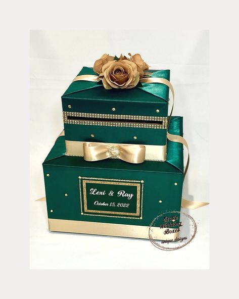 "This handmade card box/money holder is the perfect touch for your special event. Beautiful satin fabric covered two tier card box decorated with satin ribbon, silk flowers on top , rhinestone accents. We can personalize your card box with names ,event dates for no additional charge. You can choose different colored fabric , ribbon or flowers, but contact us first to discuss the custom preferences! Dimensions: 12\"L x 12\"W x 12\"H Matching Guest Book/Pen sets can be made. The card box has a Fre Emerald Green Gold Wedding Decor, Emerald Green Quinceanera Theme, Gold Wedding Card, Green Quinceanera Theme, Gold Card Box Wedding, Emerald Green Wedding Theme, Gold Card Box, Champagne Gold Wedding, Green Quince