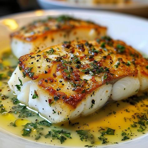 Let me introduce you to Golden Seared Cod with Herb Butter Sauce. This dish features perfectly seared cod fillets, drizzled with a rich and flavorful herb butter sauce. It's a Golden Seared Cod With Herb Butter Sauce, Fish With Lemon Butter Sauce, Herb Butter Sauce, Seared Cod, Seafood Dinners, Cod Fillets, Pan Fried Fish, Fried Cod, Wood Houses