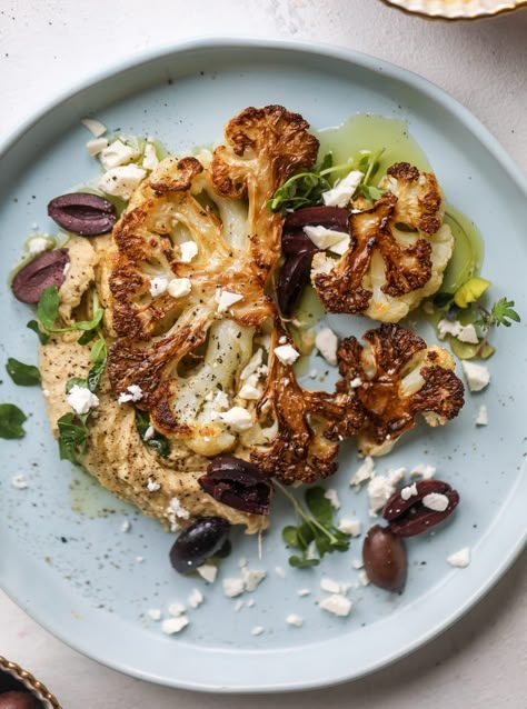 This roasted cauliflower with hummus, olives and feta is super flavorful and a wonderful meal, side dish or snack. Flavorful roasted cauliflower, creamy hummus, briney olives and tangy feta come together to make a major taste explosion. I howsweeteats.com #roasted #cauliflower #hummus #olives #feta Cauliflower Hummus, Creamy Hummus, God Mat, Cauliflower Recipes, Roasted Cauliflower, Come Together, Soul Food, Side Dish, Hummus