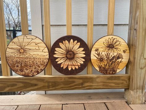 SET OF THREE woodburned Daisy designs. 10 inch wooden rounds, framed with brown leather. Picture hangers are attached on the back. Completey handmade and original designs by me :)  Perfect wall art to add to a gallery wall or as a stand alone feature! I love sets because I think it makes it easier to tie them in to a space ❤️ Small Wood Projects To Sell, Wooden Rounds, Woodburning Art, Wood Projects To Sell, Wood Burn Designs, Engraving Ideas, 3d Art Drawing, Woodburning Projects, Wood Projects That Sell