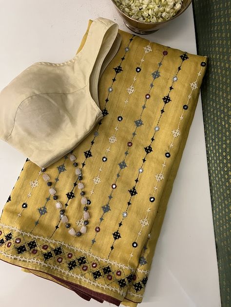 A handwoven mustard saree with with black beige and grey combination of kutch work all over the saree. The border and body of the saree has mirror work like detailing . The saree comes with a self blouse piece with work on sleeves Hand Embroidery On Saree, Isha Borah, New Dress Design Indian, Kutch Work Saree, Mustard Saree, Mirror Work Border, Work On Sleeves, Grey Combination, Cutwork Saree