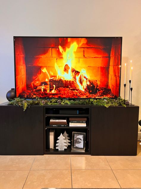 Styling a tv console, adding greenery, candles, fireplace vibes, trader joes garland, home decor Candles Fireplace, Garland Home Decor, Tv Console, A Tv, Apartment Interior, Trader Joes, Interior Ideas, Christmas Decor, Fireplace