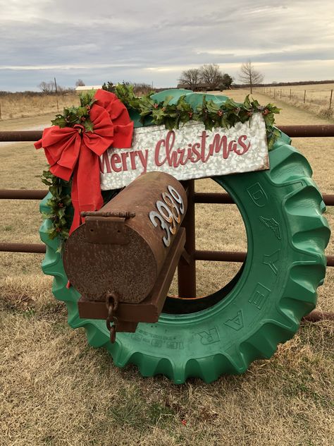 Painted an old tractor tire to make a Christmas wreath. Tractor Made From Hay Bales, Christmas Tire Projects, Tractor Tyre Christmas Wreath, Christmas Tractor Painting, Tractor Tire Wreath Christmas, Tractor Tire Christmas Decoration, Christmas Wreath Farm, Tractor Tire Pumpkin, Christmas Tractor Decorations