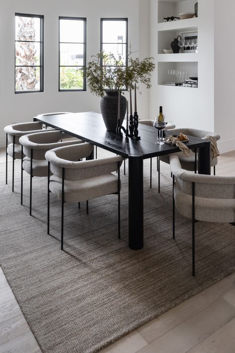 Well-rounded and honest, the Adair Dining Table's gentle geometries come alive with each dining experience. A natural beauty in solid, blackened oak with a semi-gloss finish, this dining table shows off oak's beautiful grain patterning and shades. A perfect gathering place for meals to come - natural elements and sculpture are both present with Adair. Comfortably seats 10. Dimensions: 96” W x 39” D x 29” HMaterials: Solid White OakColor: Black All items subject to availability and should not be High Top Dinner Table, Large Black Dining Table, Cozy Modern Dining Room, Black Table Dining Room, Black Dining Table Decor Ideas, Apartment Dining Table, Minimal Dining Table, Organic Modern Dining Table, Black Table Decor