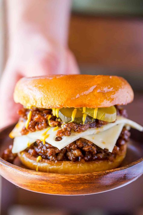 Cuban Sloppy Joes with seasoned ground pork with citrus flavors topped with Swiss cheese pickles and mustard is a Cuban take of the favorite sloppy joes! | #sloppyjoes #sloppyjoe #pork #groundpork #swisscheese #cuban #dinnerthendessert #dinner #dinnerrecipes Sloppy Joes Dinner, Cheese Pickles, Cuban Pork, Dinner Then Dessert, Ground Pork Recipes, Sloppy Joes Recipe, Sloppy Joe, Cuban Recipes, Burgers Sandwiches