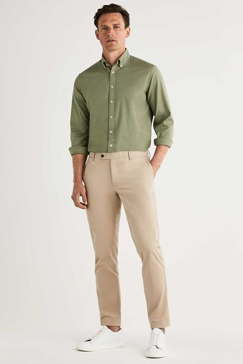 Men's khaki pants, green Oxford shirt and white sneakers outfit. This outfit first appeared in the article: What Colours To Wear With Khaki Pants: 6 Foolproof Shirt Options, on MensFlair.com Green Shirt Khaki Pants Outfit Men, Green Shirt Beige Pants Men, Green Shirt Beige Pants Outfit, Khaki Formal Outfit For Men, White Shirt Green Pants Men, Light Green Polo Shirt Outfit Men, Olive Green Polo Shirt Outfit Men, Beige Khaki Pants Outfit Men, Cream And Olive Green Outfit