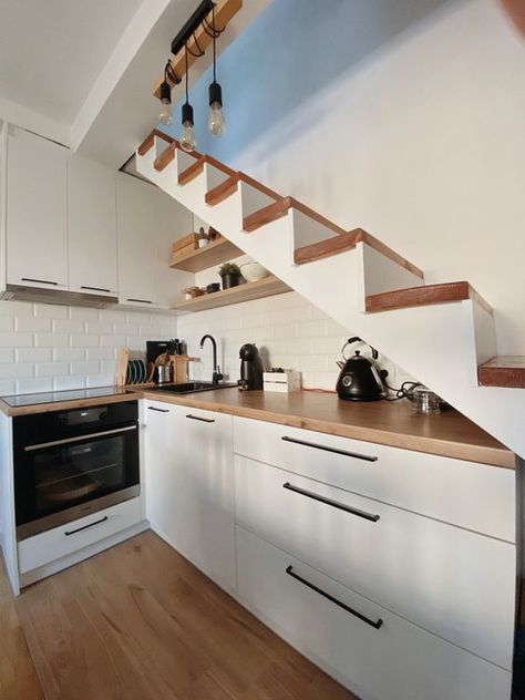 Picture of a small Scandi kitchen under the stairs, with butcherblock countertops and a white brick backsplash, pendant bulbs Kitchen Near Stairs, Kitchen Cabinets Under Stairs, Under Stairs Kitchen, White Brick Backsplash, Butcherblock Countertops, Kitchen Under Stairs, تحت الدرج, Stairs In Kitchen, Small Kitchenette