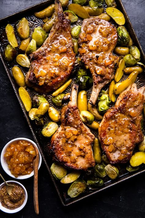 Brushed with a simple glaze, this apricot pork chop sheet pan recipe is succulent and hearty. Roasted with potatoes and Brussels sprouts, the chops make for a complete one-pan meal, too! Pork Chop Sheet Pan Dinner, Pork Chop Sheet Pan, Apricot Pork, Honey Mustard Pork Chops, Mustard Pork Chops, Cooking Pork Chops, Apricot Recipes, Modern Proper, The Modern Proper