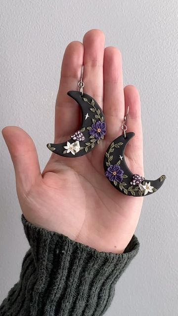 Amber Rae ❀ Handmade Nature Inspired Polymer Clay Earrings on Instagram: "Magical Mushroom Moon Earrings🍄✨ I’m basically drooling over the indigo purple color of the flowers on these bad boys. . . . . #moonearrings #witchyjewelry #handmadejewelry #polymerclayearrings #polymerclayartist #wearableart #handmadeearrings #darkaesthetic #earringdesign #earringart #dangleearrings #etsyfinds #etsyartist #etsyearrings #clayjewelry #mushroomearrings #mushroomjewelry #darkcottagecore #cottagecoreaesthetic #whimsigoth #whimsical #earringshandmade #shopsmall #slowmade #madetoorder #floralearrings #polymerclayflowers" Cool Clay Earrings, Polymer Clay Witchy Crafts, Witchy Polymer Clay Ideas, Polymer Clay Earrings Flowers, Purple Polymer Clay Earrings, Amber Rae, Clay Moon, Mushroom Moon, Fimo Earrings