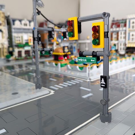 Elevate your LEGO intersections with our custom double-signal traffic light! This set features two lights with red, yellow, and green lenses, giving you realistic two-way control for busy LEGO streets. Perfectly scaled to fit right in with your builds, each light comes with interchangeable walk/don't walk signs and a custom street sign to make every corner uniquely yours. Plus, you get to choose between a black or yellow base, letting you design your city just the way you like it. This two-signa Lego Traffic Light, Lego Magazine, Custom Lego Sets, Lego City Train, Lego Plane, Lego City Ideas, Lego Build Ideas, Lego Building Techniques, Lego Furniture