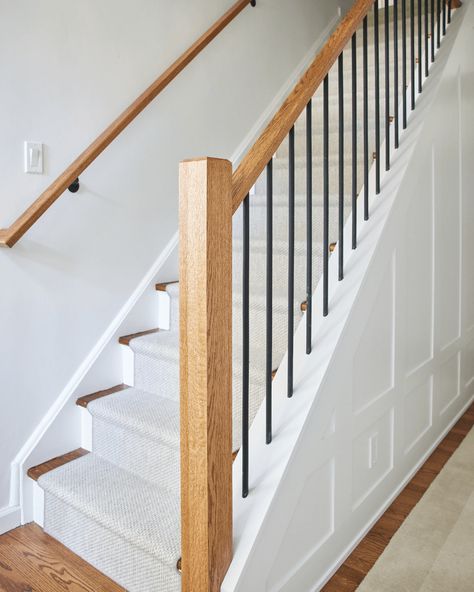 Explore the transformation of this Darien, CT home featuring a beautifully renovated staircase with red oak treads, poplar risers, and matte black iron balusters. Perfectly blending style and comfort, it’s the ideal addition to any chic home. See more from this project! #ODGxWalmsleyRoad 🏠✨ White Oak Staircase Black Railing, Oak And Iron Staircase, Wood Staircase With Black Spindles, Black Balusters Wood Handrail, Wood And Rod Iron Staircase, Wood Staircase With Iron Spindles, Stair Balusters, Iron Staircase, Oak Stairs