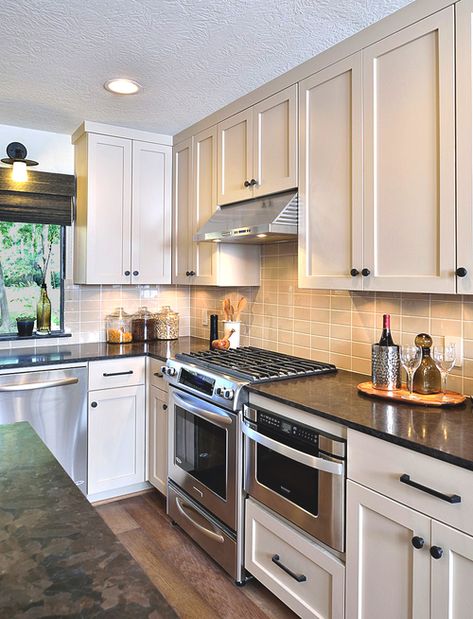 A dated 70's house gets a make-over for a young bachelor. kitchen, remodel Creamy Cabinets, Microwave Placement, Color Backsplash, Dark Granite Countertops, Simple Cabinet, Stove Hood, Double Ovens, White Kitchen Remodeling, Kitchen Backsplash Designs