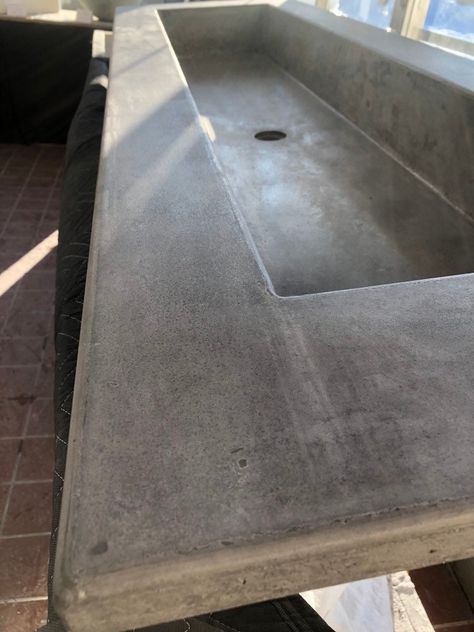 "One of the cool things about concrete is that is totally customizable. Do you want a different color, shape or size? Maybe you need unique spacing for your faucet. The possibilities are endless, and we're here to help! The gray vanity top with large trough sink in the photo is a 72\" x 22\" with a 60\" x 13\" sink.  Take a look at our store for more of our standard sized products or send us a message for a custom quote." Poured Concrete Counters, Concrete Kitchen Sink, Concrete Vanity Top, Funky Bathroom, Concrete Counter Top, Concrete Vanity, Concrete Sinks, Concrete Bathroom, Trough Sink