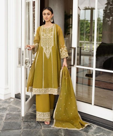 Collection - Sapphire Collection Make the perfect festive statement in our olive yellow embroidered blended textured karandi three-piece suit, featuring a flared A-line shirt, flared pants, and matching dupatta. Details: Dyed Front with Sequins & Tilla Embroidery, Dyed Back, Full Sleeves, Round Neckline Colour: Olive Yellow Fabric: Blended Textured Karandi Flared Pants Colour: Olive Yellow Fabric: Viscose Raw Silk Dupatta Colour: Olive Yellow Fabric: Blended Textured Karandi SIZE & FIT ... Tilla Embroidery, Pakistani Women Dresses, Pakistani Women, Bridal Dress Design, Three Piece Suit, Luxury Collection, Silk Dupatta, Flared Pants, Yellow Fabric