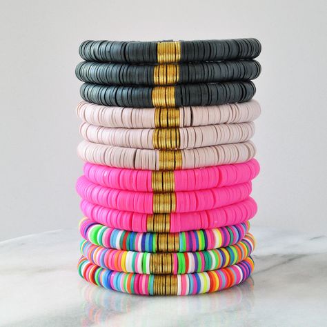 "Chunky fun heishi bead stretch bracelets are the perfect gift! And how about one (or three) for yourself, too?  + Three Sizes: Small (6.25\"), Medium (6.75\"), or Large (7.25\") + Four Colors: Multi, Hot Pink, Light Mauve and Soot + 8mm soft vinyl Heishi beads and gold-plated brass accent beads + clear stretch cord + comes packaged on a logo-stamped kraft card in a clear sleeve making it ready for gift giving + this listing is for 1 (one) bracelet PREFER A WOOD AND HEISHI NECKLACE?  Visit this Adjustable Stacked Stretch Bracelet For Beach, Adjustable Black Heishi Beads Stretch Bracelet, Beach Black Heishi Beads Bracelet, Adjustable Black Stretch Bracelet For Beach, Polymer Bracelets, Disc Bead Bracelet, Bracelets Clay, Bead Stretch Bracelets, Heishi Bracelets