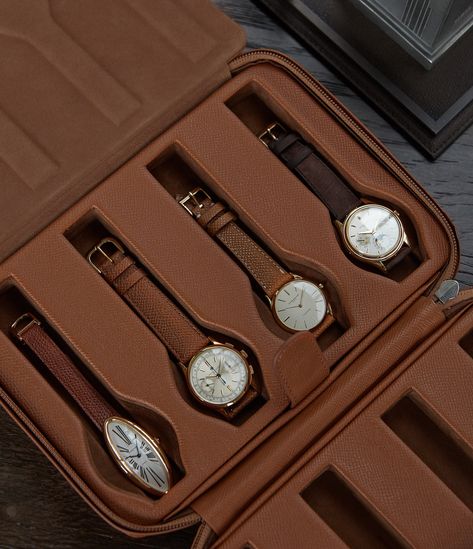 This watch case can hold up to eight watches. Produced using a firm external frame and grained calfskin leather, it’s tanned to a warm orange brown colour. The case is secured by a concealed, coil zip in matching colour, which - while keeping the case compact - allows the two sides to lay completely flat and to comfortably store and access the watches.  The two-part interior has a supple, warm mocha suede lining, separated by a grained calfskin and suede divider, with watch-shaped, padded cushio Rectangular Brown Watch Accessories With Case, Luxury Brown Watch Accessories With Case, Brown Leather Watch Accessories With Case, Classic Rectangular Business Watch Case, Leather Watch Accessories With Case, Rectangular, Buy Watch, Jewelry Cases, Watch Boxes, Mens Travel