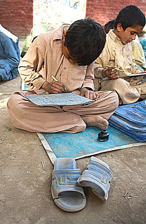 Student of a village elementary school practices writing on his note-book folded like a ‘takhti’, Lode A Dio, Pakistani Art, Thar Desert, Pakistani Culture, Schools Around The World, Education In India, Two Sons, Village Photography, Islamic Republic