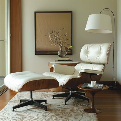 Featuring a sleek solid wood frame and top-grain genuine leather upholstery, this chair offers an ergonomic design with a deep seat, wide armrests, and a 110-degree tilt for unparalleled relaxation. Meticulously crafted with options in light walnut, dark walnut, or rosewalnut veneers, and supported by a die-cast aluminum swivel base, it provides both durability and elegance. Complete with a matching ottoman, the Lounge Chair enhances any living room, study, or executive office with its sophistic Leather Lounge Chair With Ottoman, Living Room With Leather Recliner, Vintage Recliner Chair, Eames Lounge Chair Living Room Interiors, Chair And Ottoman Living Room, Modern Swivel Chair Living Room, Bedroom Lounge Area Ideas, Eames Lounge Chair Living Room, Eames Chair Living Room