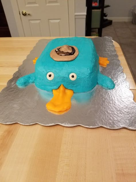 Perry the Platypus cake Perry The Platypus Makeup, Perry The Platypus Cake, Platypus Cake, Goofy Cake, Final Cake, Funny Cakes, Bad Cakes, Ugly Cakes, Cakes To Make