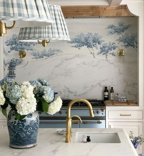 Beautiful French country kitchen with blue accents including range, tree mural behind it, and gingham fabric on shades - via Style Secrets Magazine. #frenchcountrykitchen #bluekitchens French Cottage Backsplash, Blue Floral Kitchen, French Cottage Kitchen Ideas, Kitchen Wallpaper Blue, Blue French Country Kitchen, French Country Backsplash, Kitchen With Blue Accents, White French Country Kitchen, Wallpaper Backsplash Kitchen