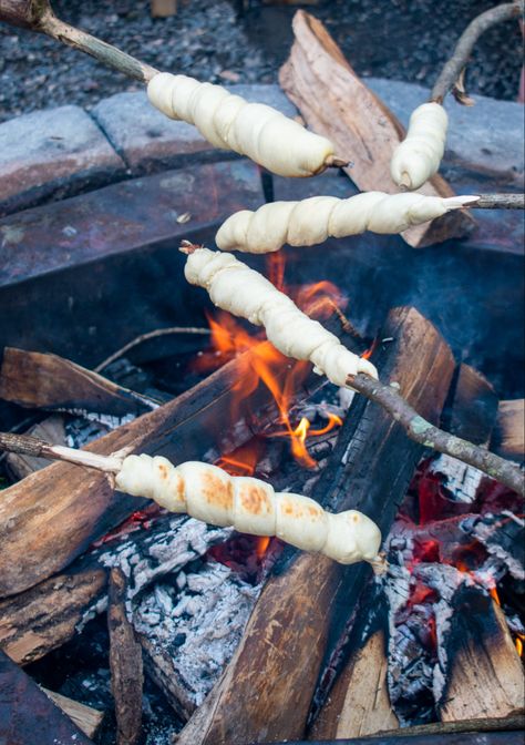 Bread wrapped around a stick that is being cooked over a campfire. Cooking Over Fire, Open Fire Cooking, Fire Food, Campfire Food, Choco Chips, Fire Cooking, Campfire Cooking, Camp Fire, Open Fire