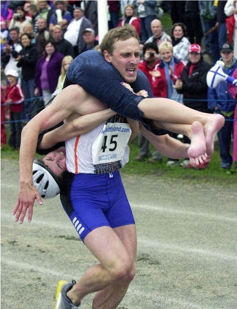 Wife carrying (Estonian: naisekandmine, Finnish: eukonkanto or akankanto, Swedish: kärringkånk) sport which males carrying a female. Goal, male to carry the lady through an obstacle track in best time. Sport first held at Sonkajärvi, Finland. Types of carry practiced: piggyback, fireman's carry, or Estonian-style (wife upside-down w/ legs around husband's shoulders, holding his waist). World Championships held yearly in Sonkajärvi, Finland since 1992, prize is the wife's weight in beer. Fireman's Carry, Wife Carrying, Find A Husband, Cultural Events, New Beginnings, Finland, Norway, Beautiful People, Transportation