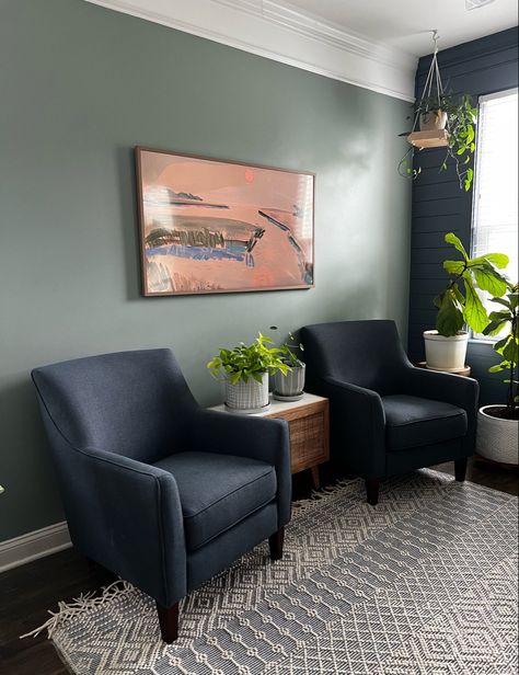 Loving these navy chairs, green walls, and of course the frame TV in our living room! Follow my shop @CharlestonCrafted on the @shop.LTK app to shop this post and get my exclusive app-only content! #liketkit #LTKFind #LTKfamily #LTKhome @shop.ltk Navy And Green Lounge Ideas, Dark Blue And Sage Green Living Room, Green Tv Room Ideas, Green Wall Blue Sofa, Navy Couch Green Walls, Navy Green Living Room, Sage Green And Navy Living Room, Navy Blue And Sage Green Living Room, Green Navy Living Room