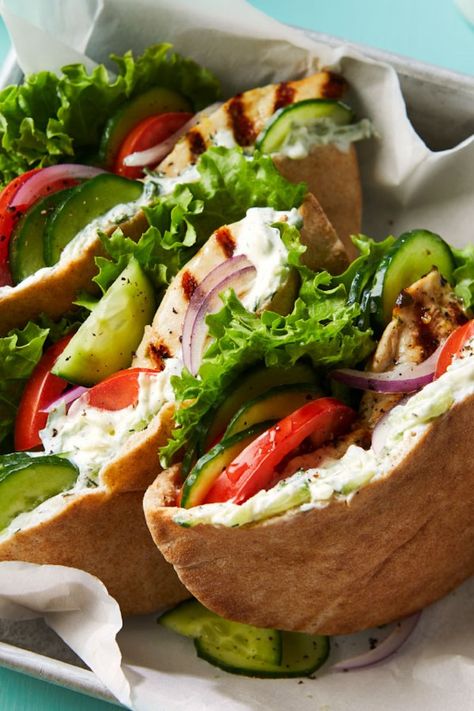 Cucumbers do double duty in this healthy Greek chicken pita recipe—they're grated to lend a refreshing flavor to the quick cucumber-yogurt sauce and sliced to provide cool crunch tucked into the pita. Serve these Mediterranean sandwiches for a healthy dinner or light lunch. #lunch #lunchideas #healthylunchideas #healthylunches #healthylunch #lunchrecipes #sandwichrecipes #wraprecipes #lunchwraps #recipe #eatingwell #healthy Sauce For Chicken Sandwich, Yogurt Sauce For Chicken, Chicken Pita Recipes, Greek Chicken Pita, Mediterranean Lunch, Protein Sandwich, Chicken Cucumber, Pita Sandwich, Diet Lunch Ideas