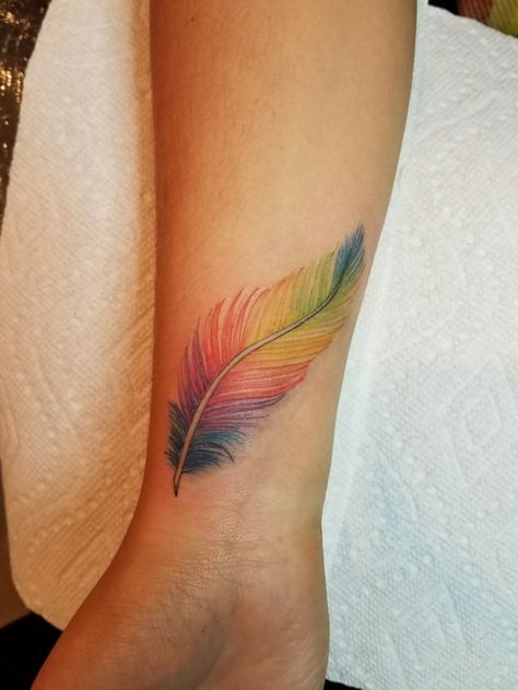 Free Bird Tattoo, Tattoo Para, Feather Tattoo Wrist, Small Feather Tattoo, Feather Tattoo Colour, Pixie Tattoo, Rainbow Feather, Freedom Tattoos, Tattoo Lettering Styles