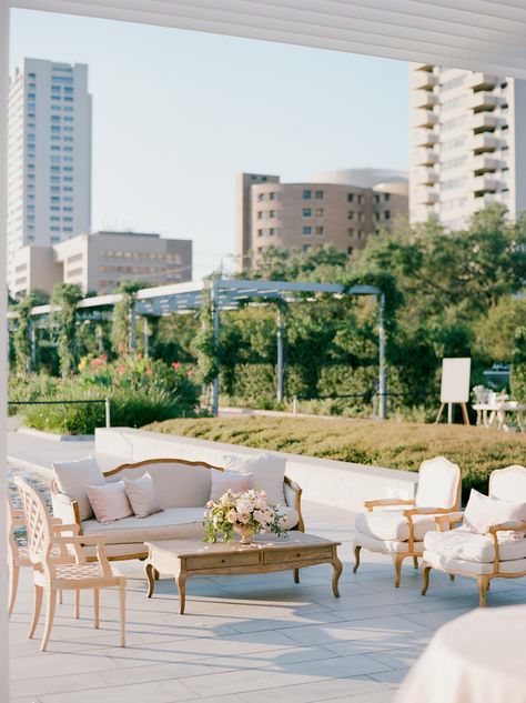 Guests attended cocktail hour in the main garden of the venue. Some people stood at cocktail tables while others relaxed at a seating area with an ivory couch, chairs, and wooden accents. Passed hors d'oeuvres by Café Natalie included coconut lobster skewers, bulgogi on jalapeño corn cakes, and fried mac 'n' cheese balls. Cafe Seating Area, Trendy Cafe, Urban Scenery, Couch Ideas, Cafe Seating, Wedding Lounge, Wedding Venue Houston, Jose Villa, Romantic Garden Wedding