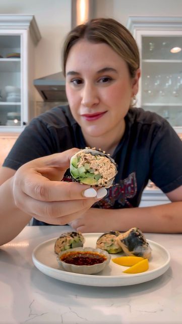 Nadia Aidi on Instagram: "Spicy Tuna Spring Rolls…I’ve been eaten these borderline too much because they are high in protein, they’re easy, quick and freaking awesome.  Ingredients: * 4-6 spring roll wrappers. * 2 cans of tuna packed in water. * 2.5 tbsp japanese mayo. * 1.5 tbsp sriracha. * 1/4 cup green onion. * 1/2 tsp toasted sesame oil. * Cucumber slices. * Avocado slices. * Toasted sesame seeds. * 1 tbsp salsa macha or chili crisp. * 3 tbsp tamari or soy sauce. * 1/2 lemon. * 2 tsp rice vin. * 1 tsp agave. * Mini nori squares.  Directions: 1. Mix the tuna, green onion, mayo, sriracha and sesame oil. Mash well. 2. Mix the tamari, salsa macha, agave, lemon and rice vin. 3. Soak your wrappers in cold water for 15-20 sec max. 4. Add the nori sheet in the center towards the edge of the wr Tuna Spring Rolls, Cucumber Avocado Rolls, Japanese Mayo, Toasted Sesame Oil, Chili Crisp, Spring Roll Wrappers, Cucumber Slices, Avocado Slices, Spicy Tuna