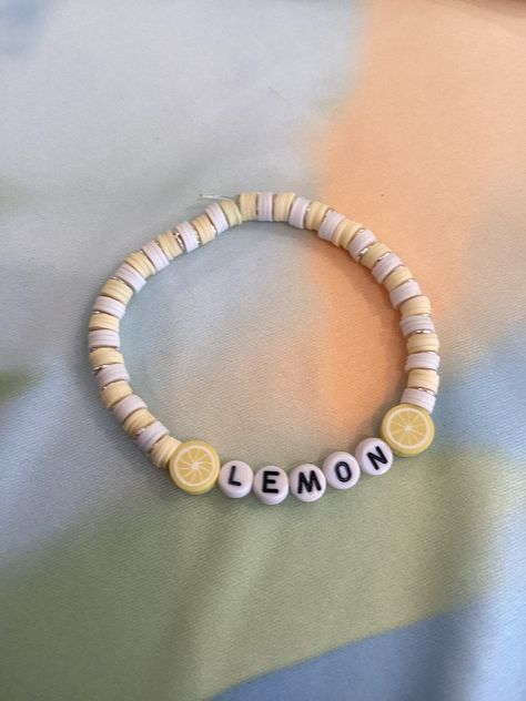 A beautiful bracelet that showcases the amazing fruit lemons. It also shows the colors yellow and white. Handmade with clay beads. Yellow Clay Bead Bracelet, Lemon Bracelet, Pulseras Aesthetic, Make Clay Beads, Fruit Bracelet, Beaded Braclets, Diy Beaded Rings, Preppy Bracelets, Clay Bead Bracelet