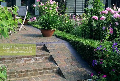 Shallow brick steps leading to patio with ramp on the side for wheel barrow access Patio With Ramp, Garden Steps Diy, Outdoor Ramp, Shed Landscaping, Landscape Stairs, Brick Steps, Wheel Barrow, Sloped Backyard, Garden Stairs